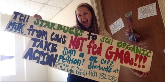 Missy Martin 2017 Project Green Challenge winner holding up an anti-GMO sign.